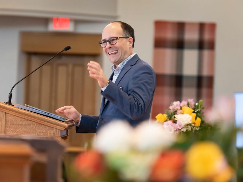 Dean Edgardo Colón-Emeric at OBCS 50th Anniversary speaking in blue suit