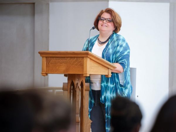 Chaplain Meghan Benson speaks at the 2025 Graduate Cross Service
