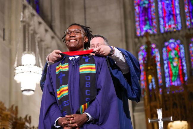 Student receives hood at the 2025 Baccalaureate Service.