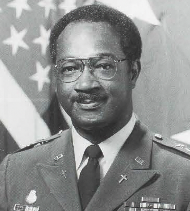 Matthew Zimmerman in army attire in front of American flag