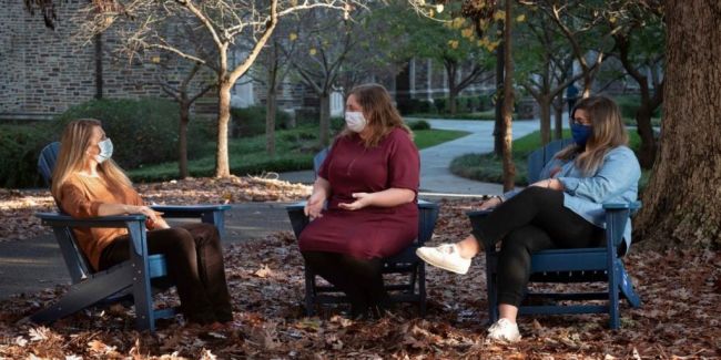 Angie Hoen sits with two members from her Sojourner group, Ruth Ostler and Mackenzie Fair