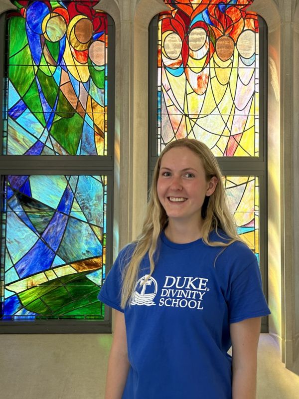 Nicole Kallsen headshot in front of stained glass window