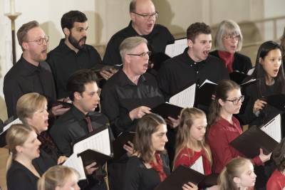 Member of the chorus sing in Goodson Chapel