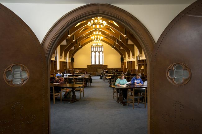 Students studying inside the York Room, as seen through the open ornate doors