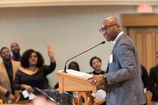 Michael Walrond preaches with congregants in background in Goodson Chapel