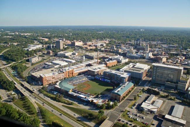 Aerial shot of the city of Durham with the Durham Bulls Stadium in the foreground and various building in the background