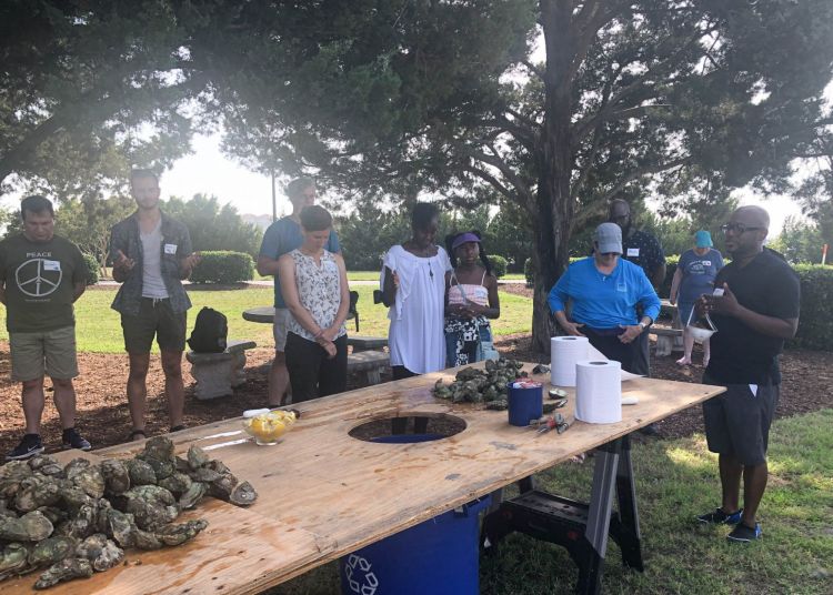Norbert Wilson leads outdoor prayer at climate retreat before mealtime