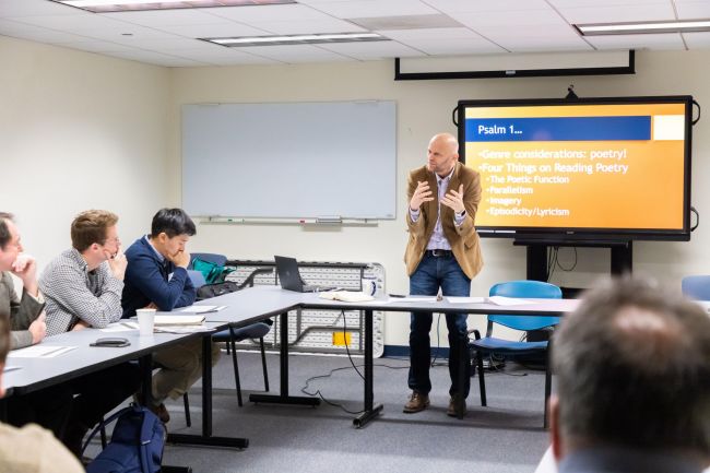 Brent Strawn teaches a seminar with a slide projected in background