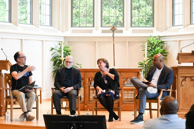 Faculty members sit at the front of Goodson Chapel for a panel discussion