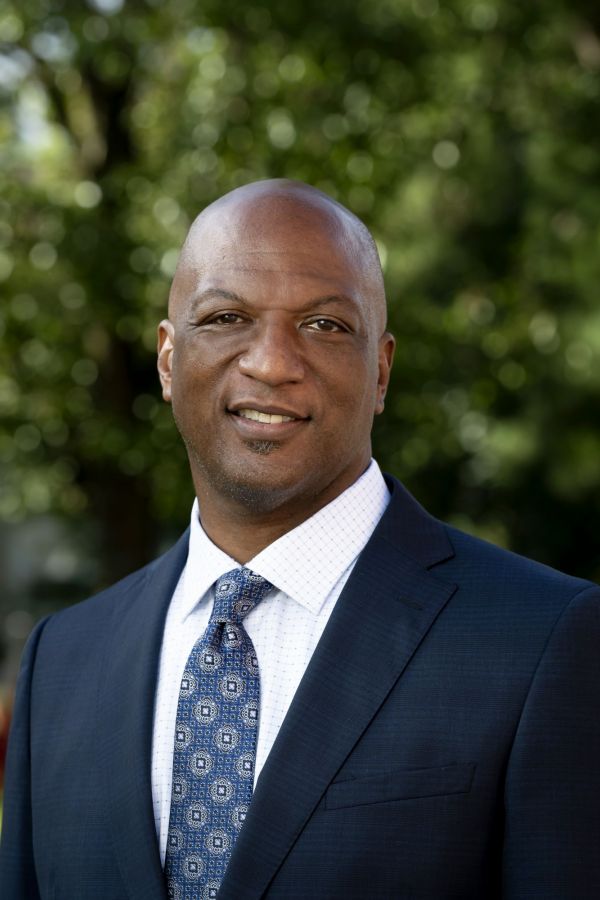 quinton dixie headshot in suit taken outdoors