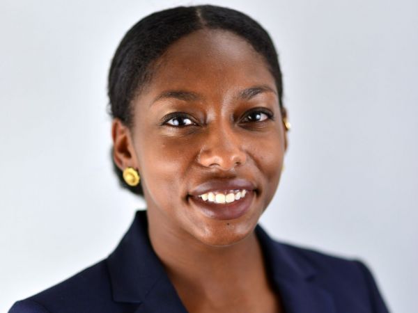 Danielle Ellis wearing a navy blazer and gold earrings