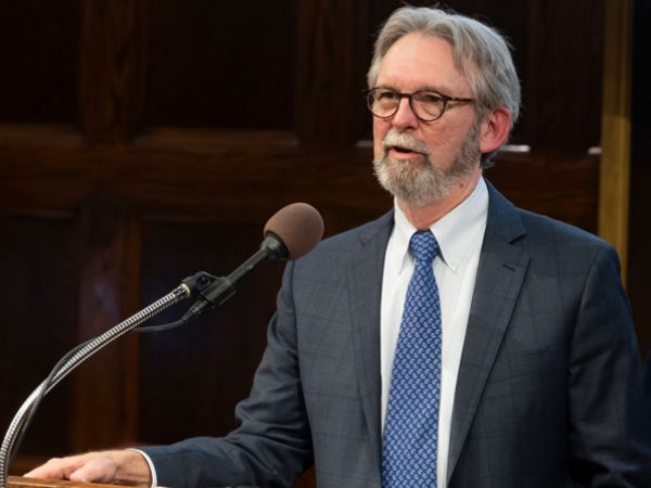 Richard Hays at a podium with a microphone