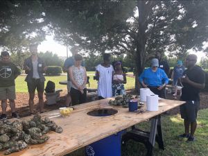 Norbert Wilson leads outdoor prayer at climate retreat before mealtime