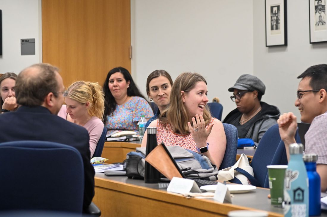 Participants in the “Artificial Intelligence, Ethics, and Catholic Thought” seminar converse in a classroom.