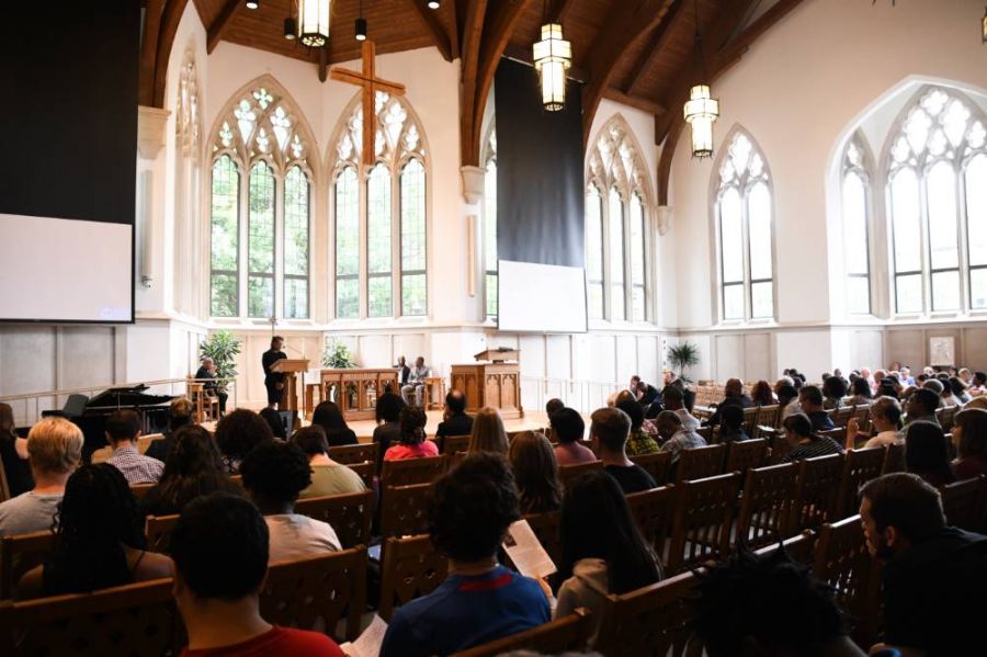 Congregation in Goodson Chapel with reader speaking from the lectern.