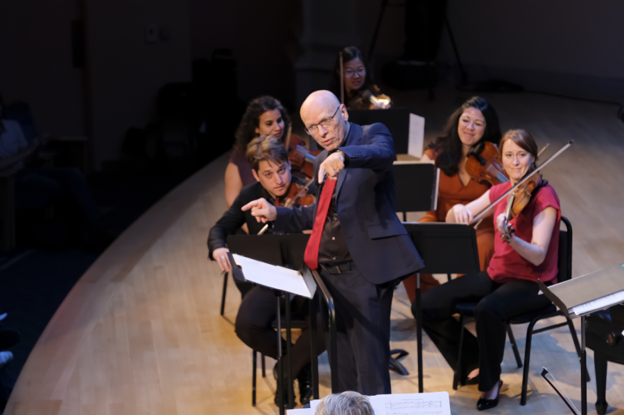 Man conducting musical ensemble