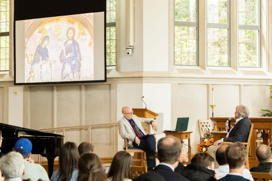 speakers discussing an icon of the virgin Mary and Jesus