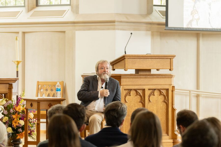 Speaker holding microphone and addressing a crowd