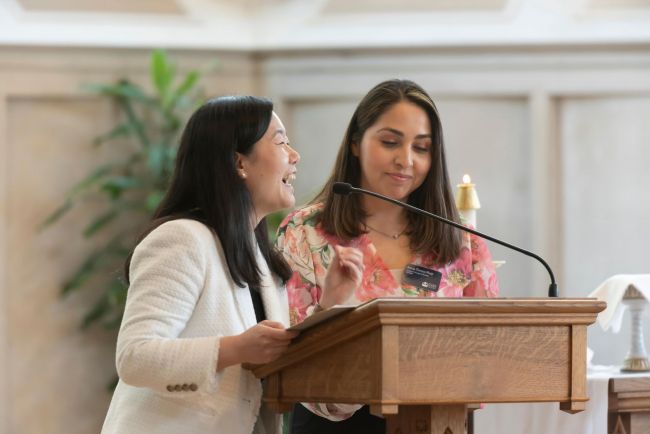 Jung Choi and Alma Ruiz speak during worship service