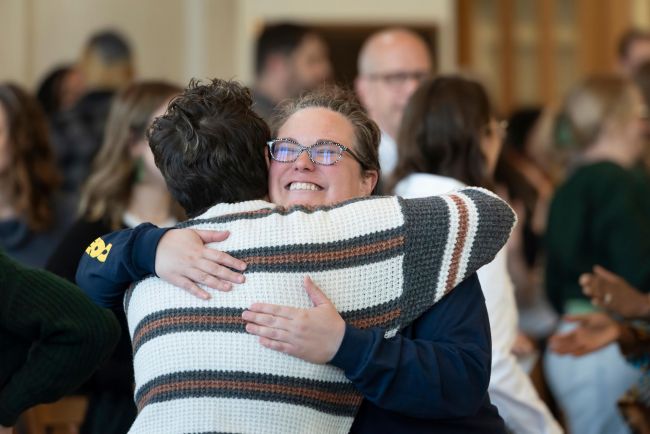 Students hug during worship service