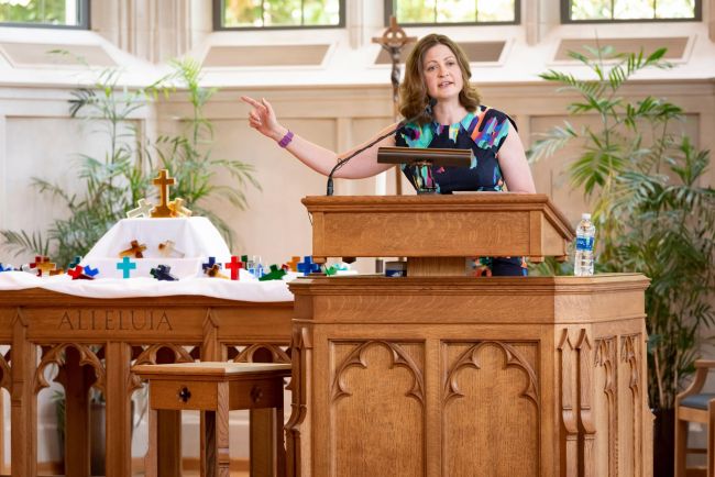 Thea Portier-Young preaches in Goodson Chapel with glass crosses in background