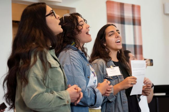 Students and alumni sing together during the Hispanic House anniversary in Goodson Chapel