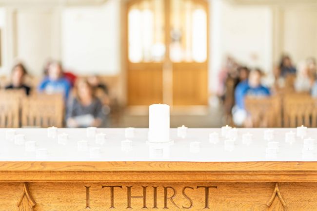 Candles on altar with "I thirst" carving