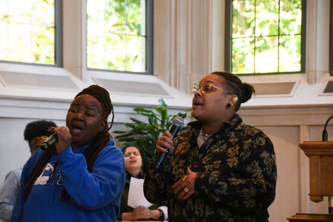 Two students from Gospel Choir sing in the chancel of Goodson Chapel