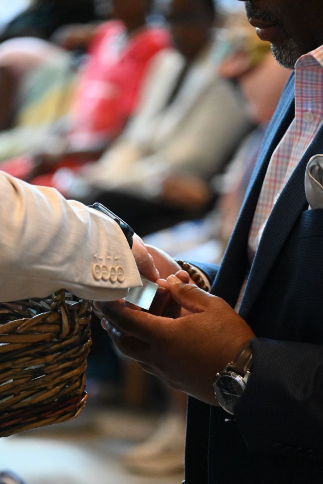 Student receives glass cross at hybrid graduate cross service