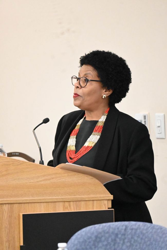 Valerie Cooper moderating the panel during the Women's Center 50th Anniversary