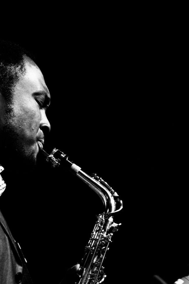 Black and white photo of musician playing saxophone