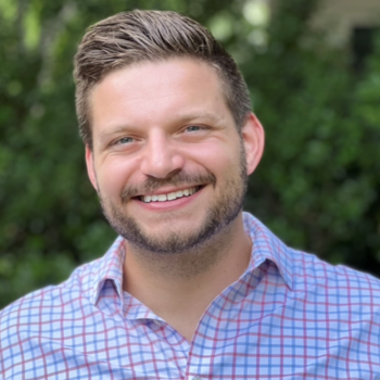 Bryan Launer wearing a red and blue plaid button down shirt