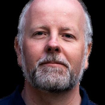headshot of man against black background