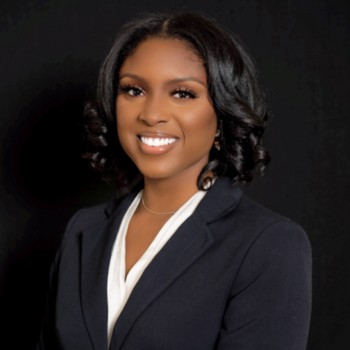 Crystal Fuller smiling wearing a white shirt and black blazer