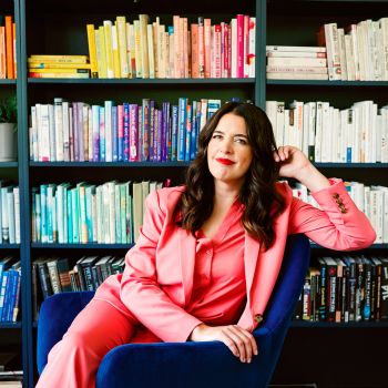 Kate Bowler seated n front of bookshelves