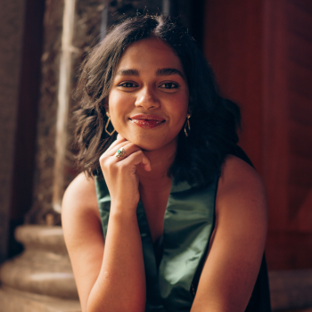 Namrata Matthew smiling wearing a green top and earrings