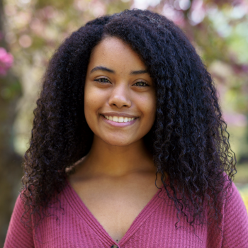 Sophia Sparrow smiling wearing a mauve sweater