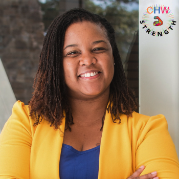 Stephanie Toney smiling wearing a blue shirt and yellow blazer