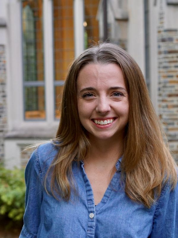 Katie Mangum headshot in blue shirt